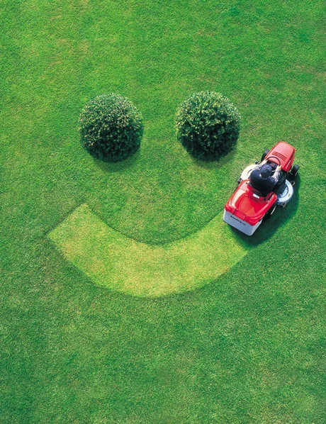Lawn mower drawing a giant smile in the grass